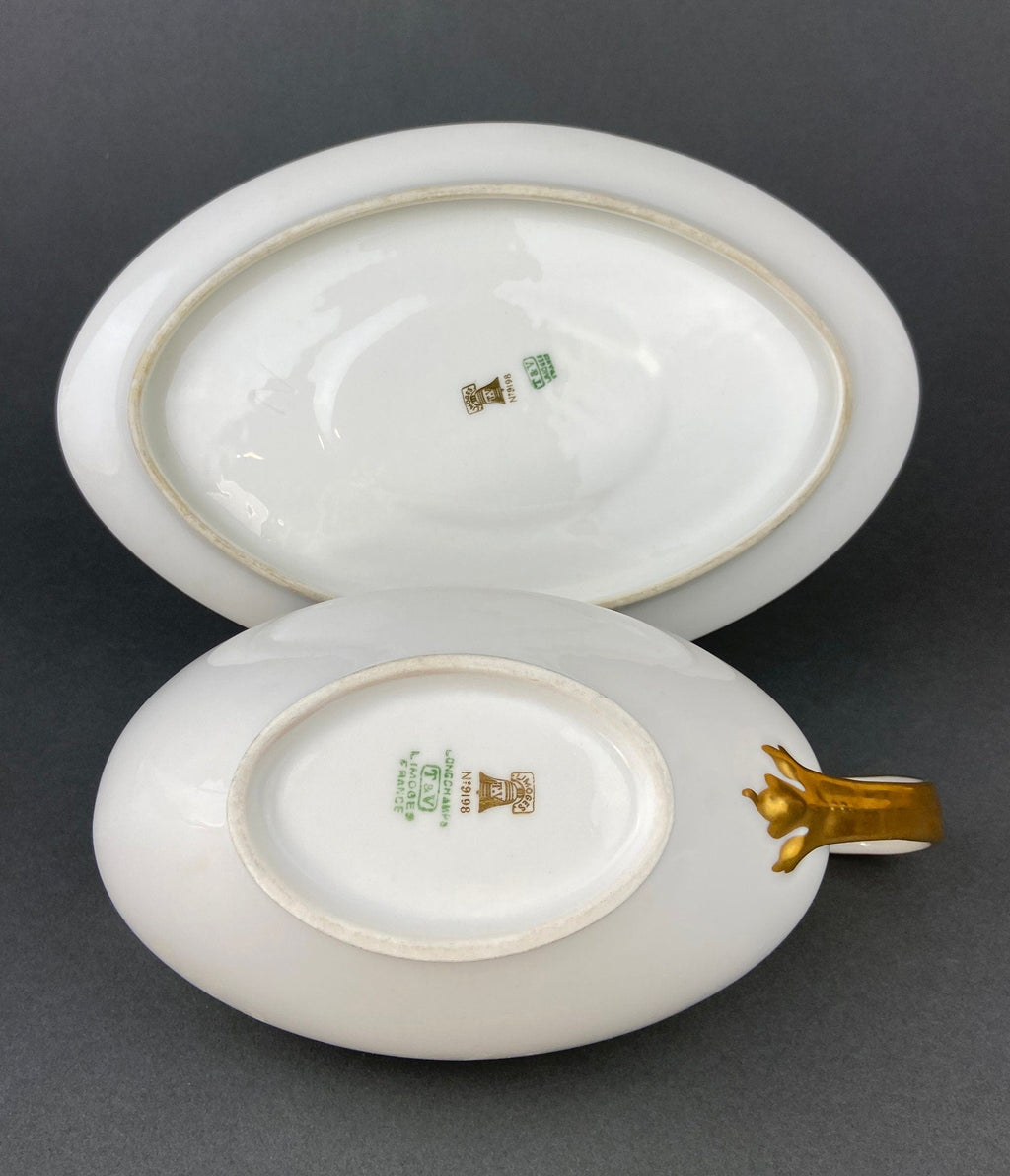 White porcelain gravy boat base with gold-trim ring and maker stamp