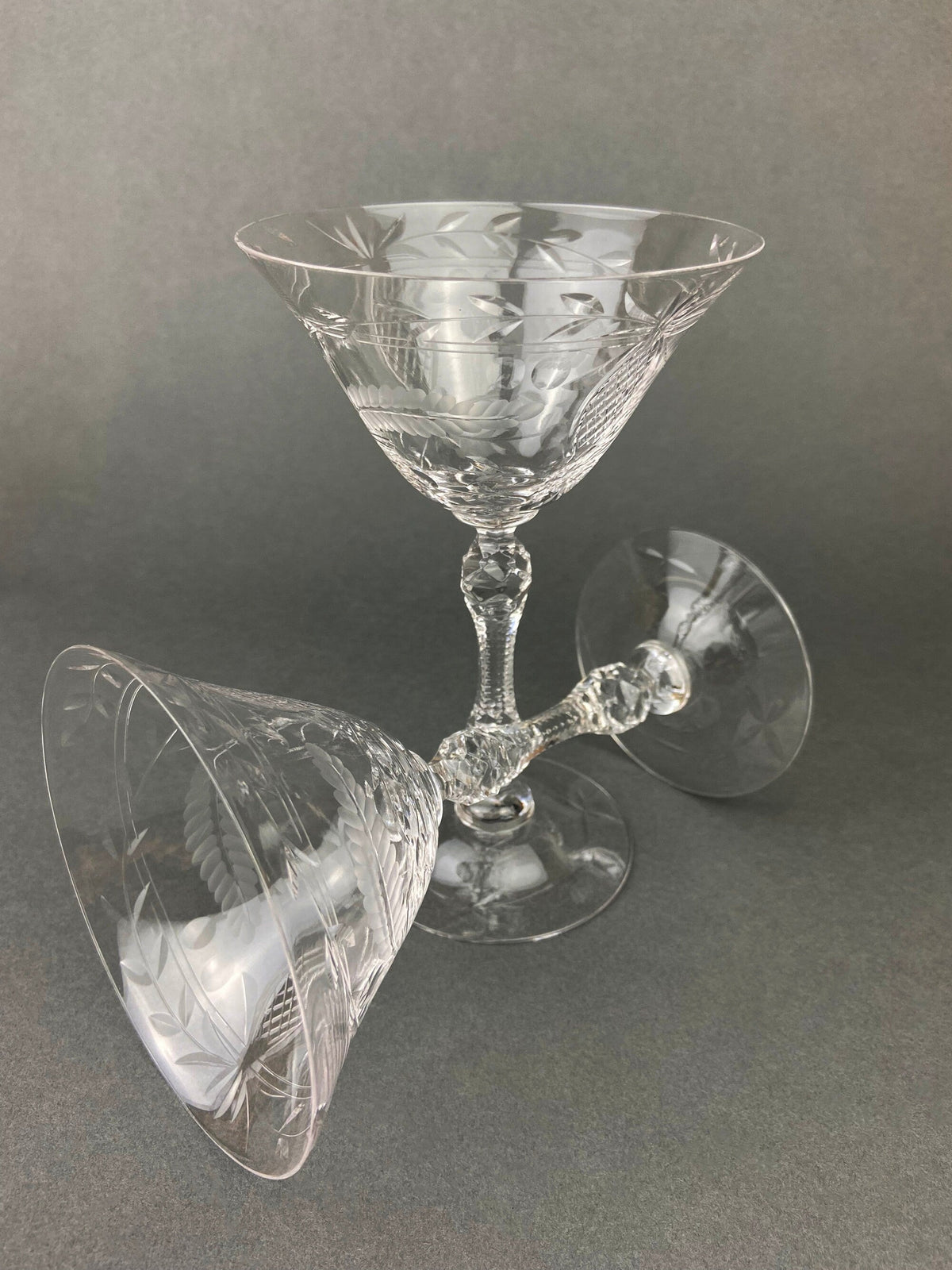 Cut crystal champagne glass with leaf-cut pattern on the bowl and clear stem
