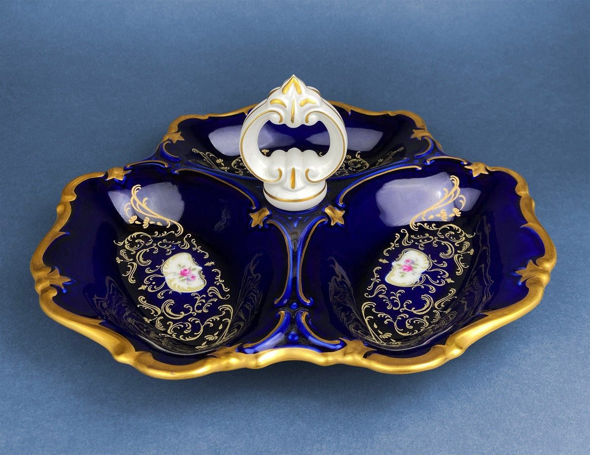 Porcelain divided bowl with handle, dark blue glaze, gold trim, floral medallions