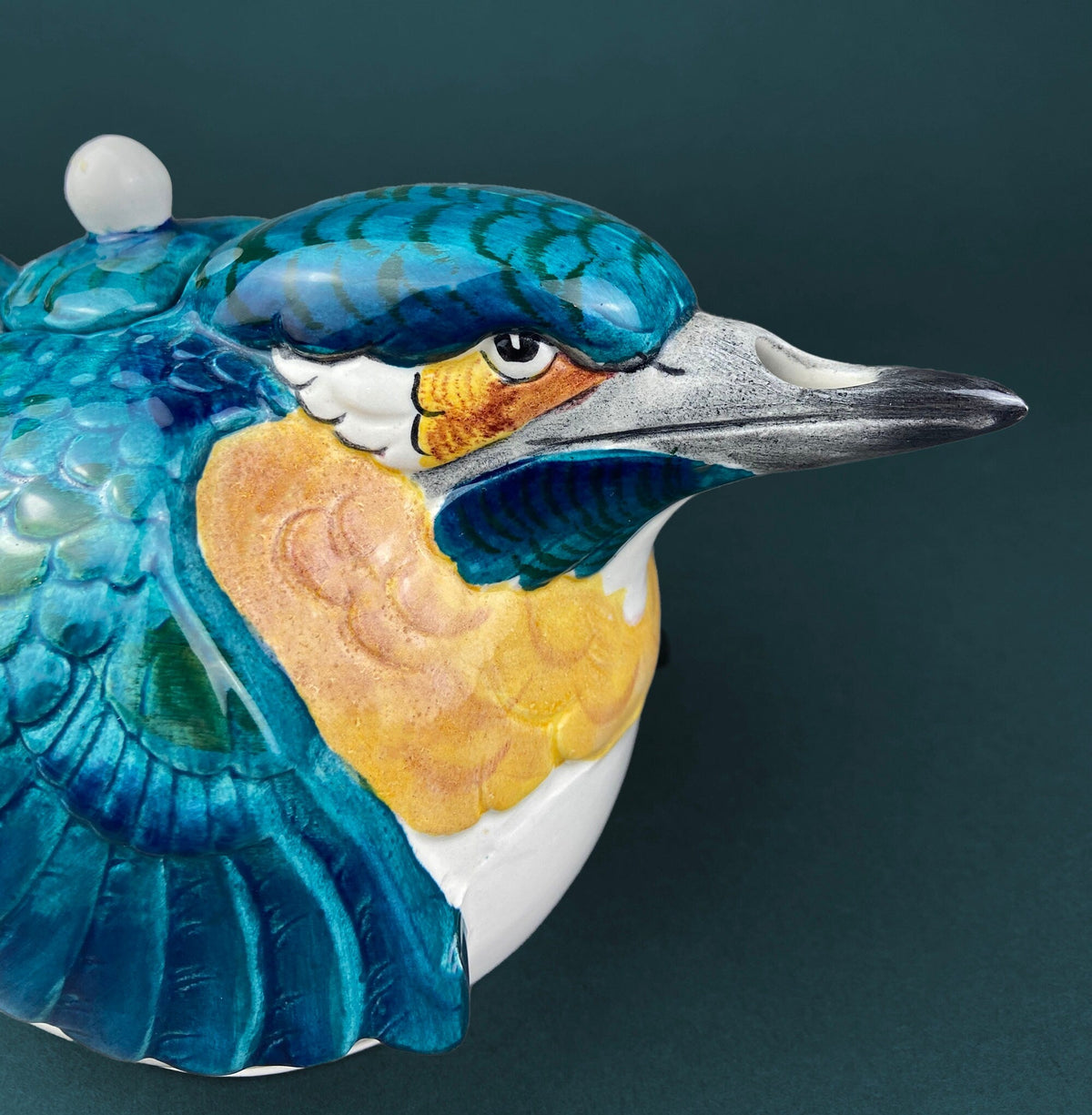 Blue bird ceramic teapot spout and head detail with small white finial