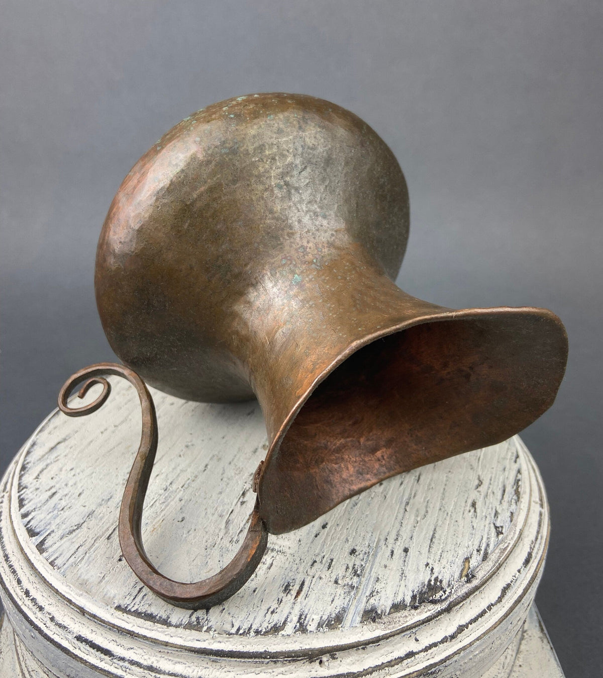 Vintage copper jug with swirl handle, wide spout, and hammered patina finish