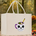 Natural canvas Halloween tote bag for kids with smiling skull cup graphic and long handles