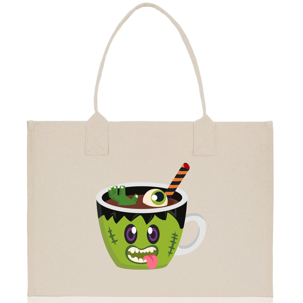 Natural canvas tote bag with green monster potion cup Halloween graphic and white handles