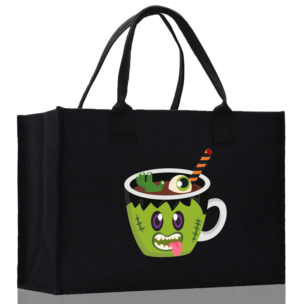 Black canvas tote bag with green monster potion cup Halloween graphic, wide side view