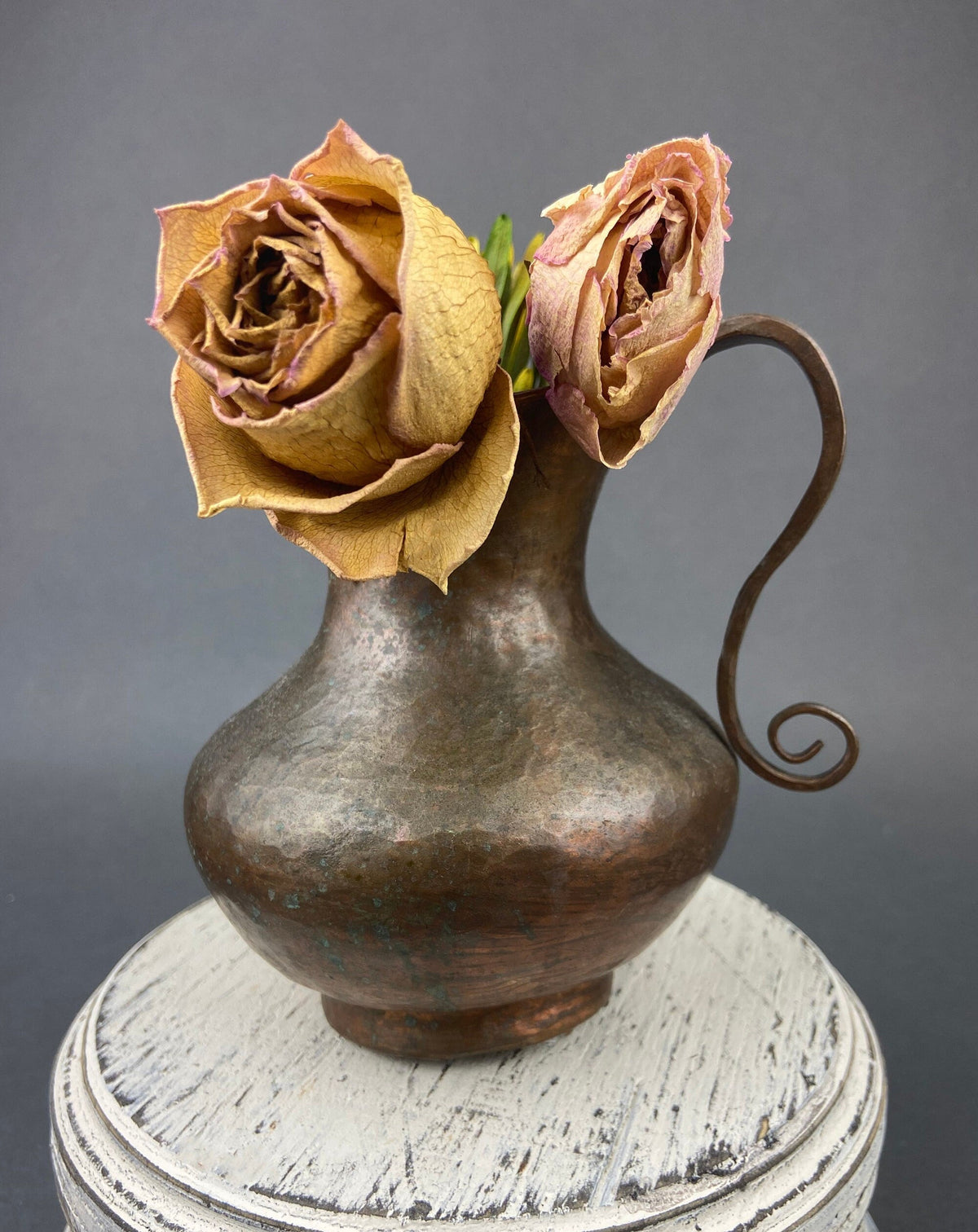 Vintage copper jug with swirl handle, bell-shaped body, and hammered texture
