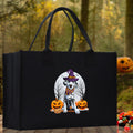 Black canvas tote bag with cartoon witch dog and jack-o'-lanterns on the front.