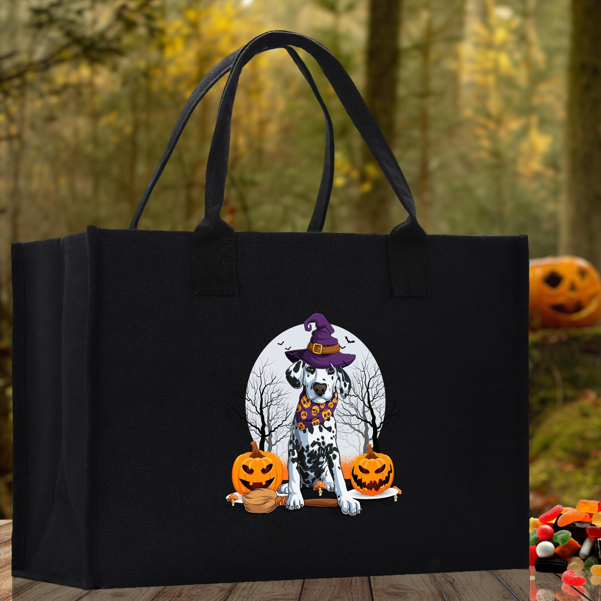 Black canvas tote bag with cartoon witch dog and jack-o'-lanterns on the front.