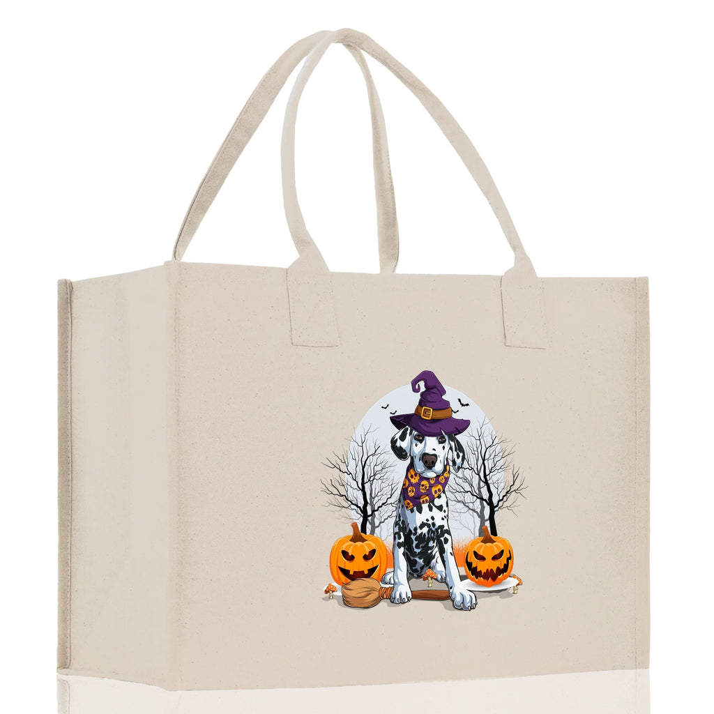 Natural canvas tote bag with front print of a cartoon witch dog and jack-o'-lanterns.