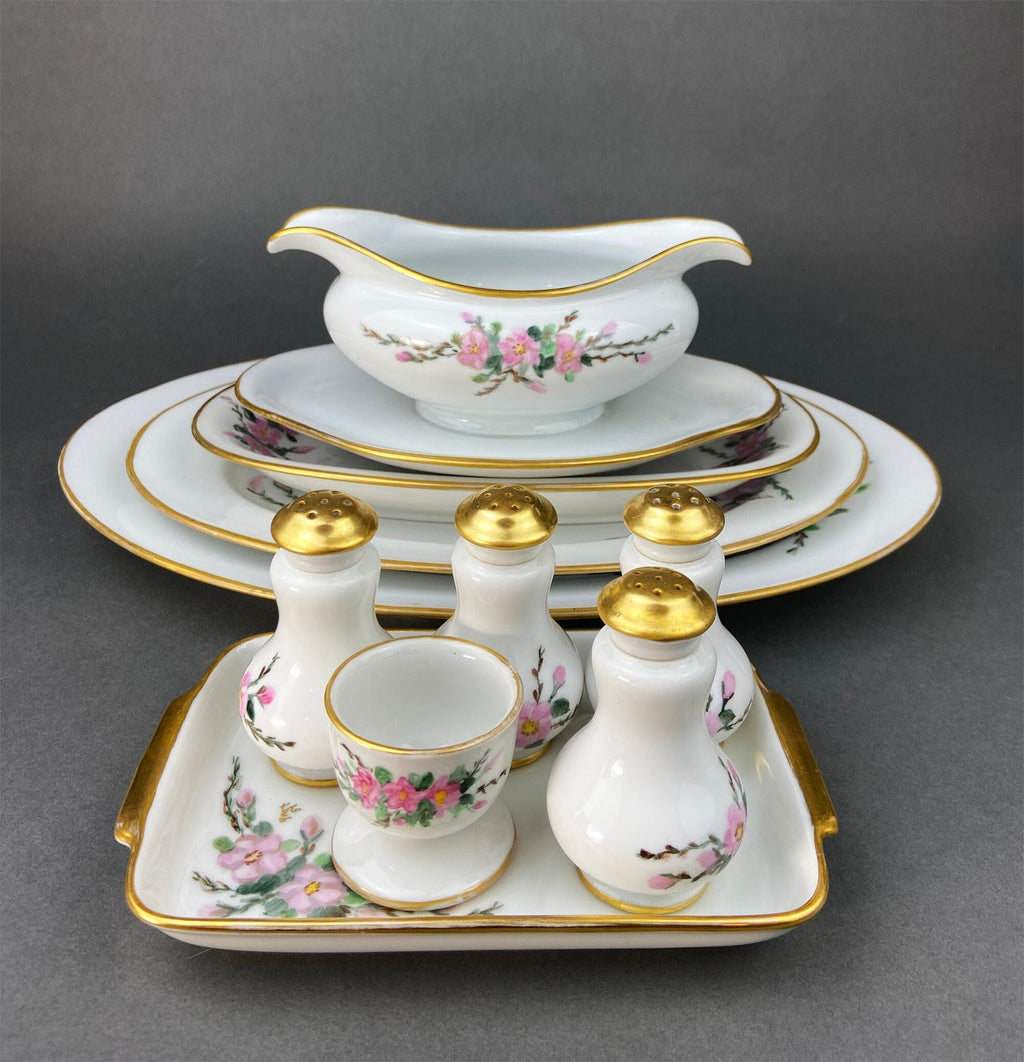 Porcelain sauce boat with oval platter and gold rim detailing