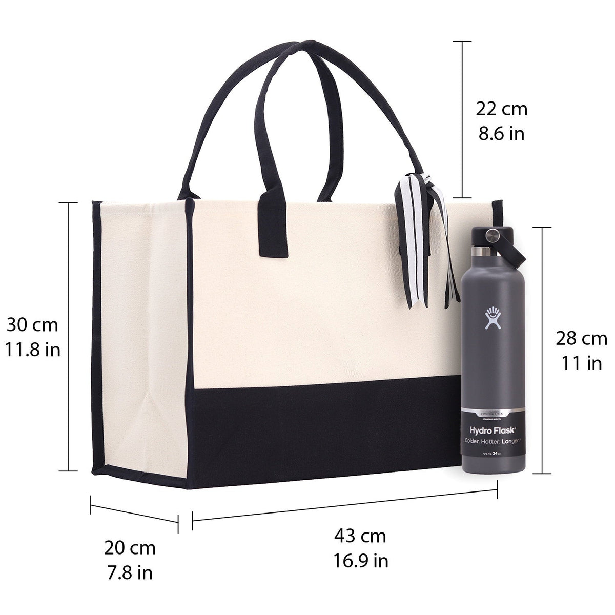 Measured Halloween canvas tote bag with black trim, handles, and striped bow