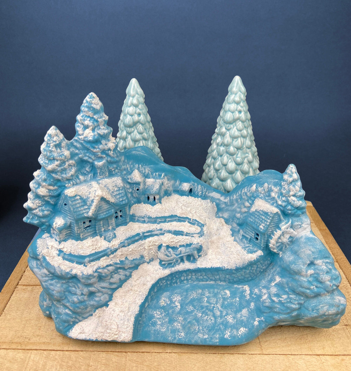 Blue ceramic Christmas village scene with curved bridge and tiny house details