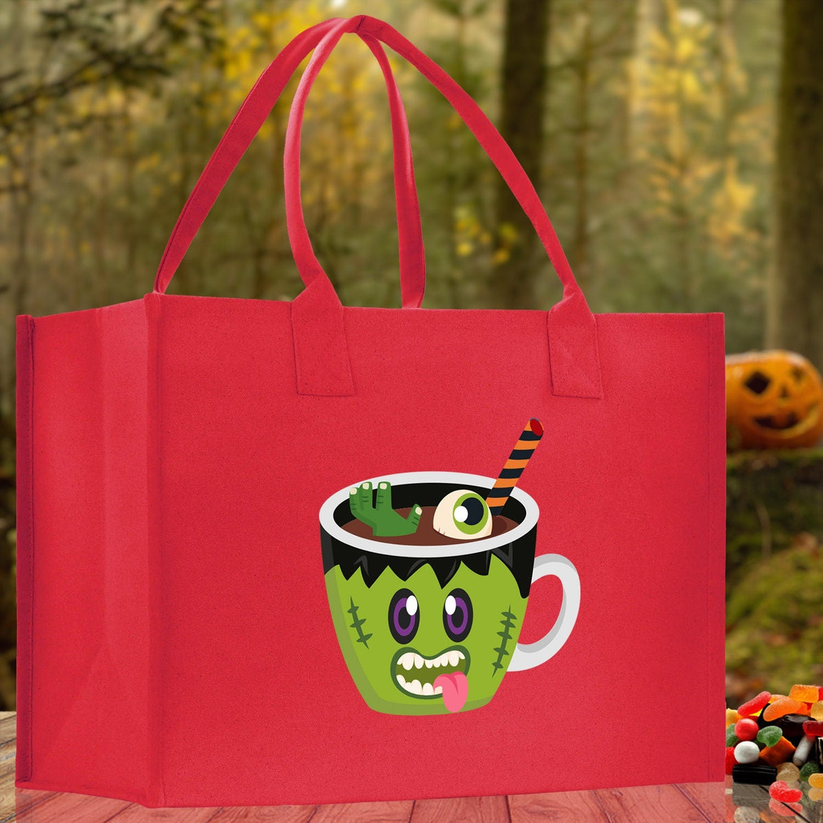 Red canvas tote bag with green monster potion cup Halloween graphic and red handles