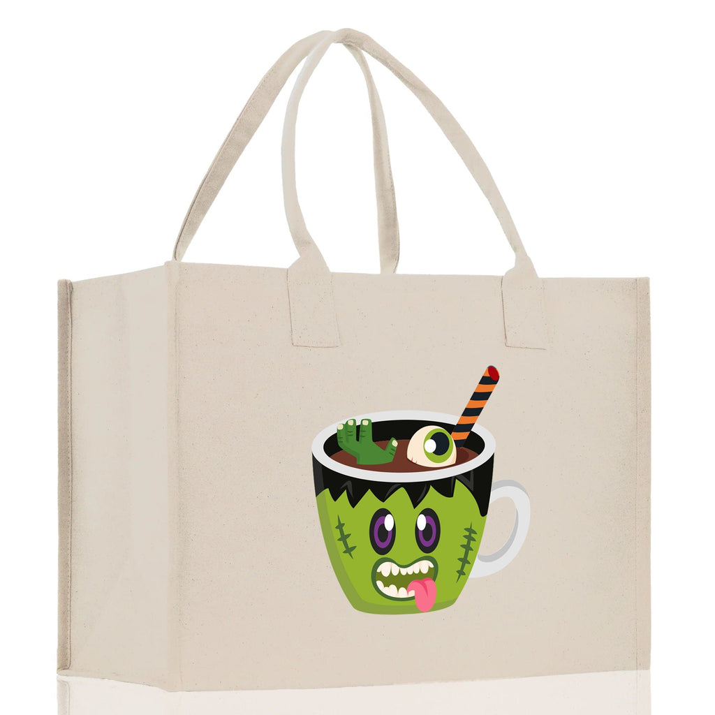 Natural canvas tote bag with green monster potion cup Halloween graphic and double handles