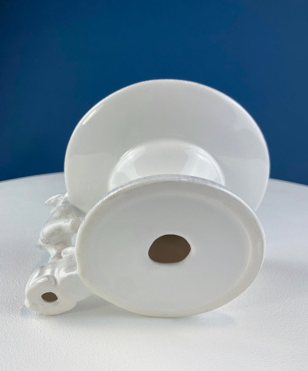 White ceramic bunny cupcake stand with two stacked round plates and bunny base detail