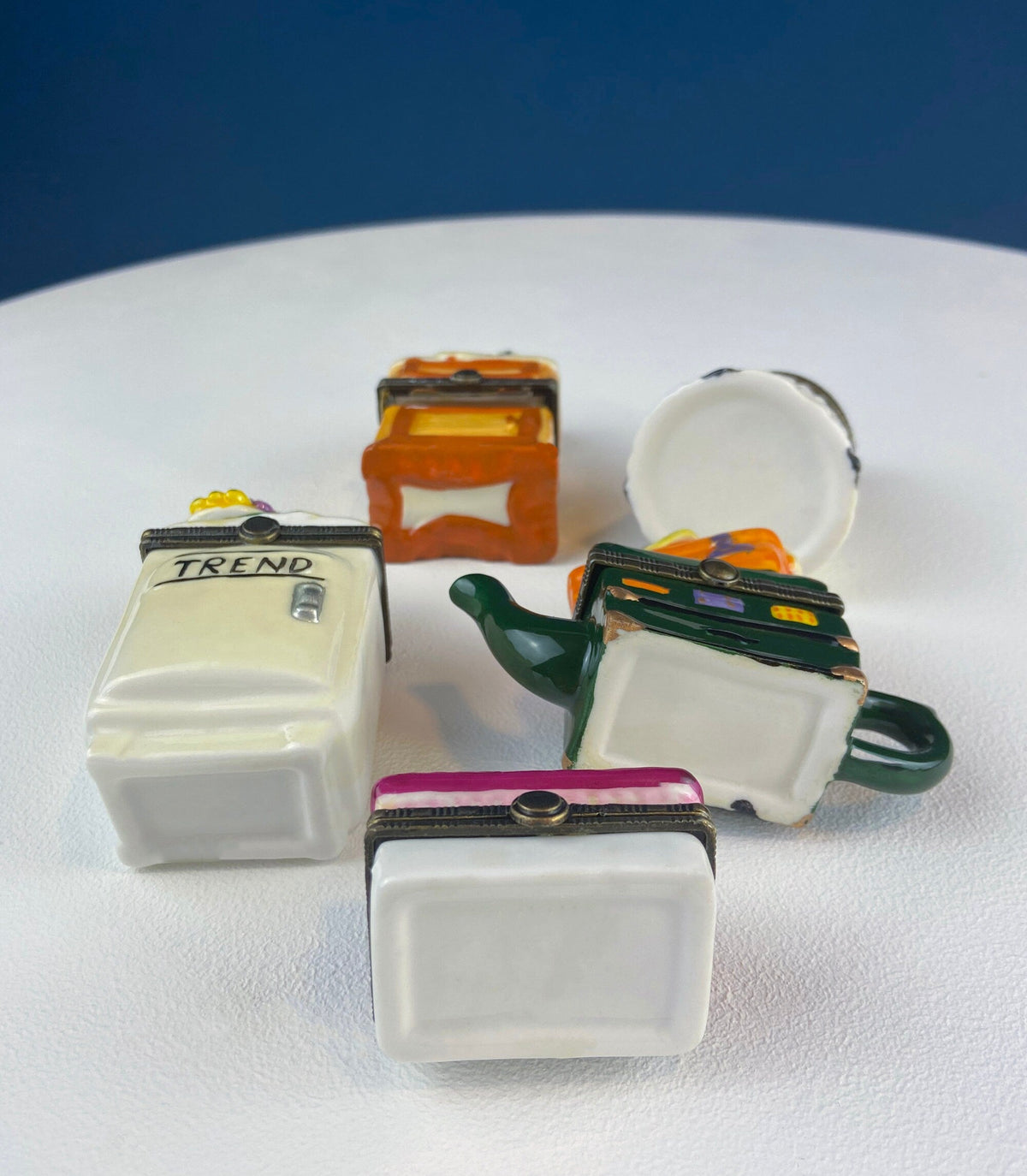 Miniature porcelain pill boxes, table scene shapes with one hinged lid open