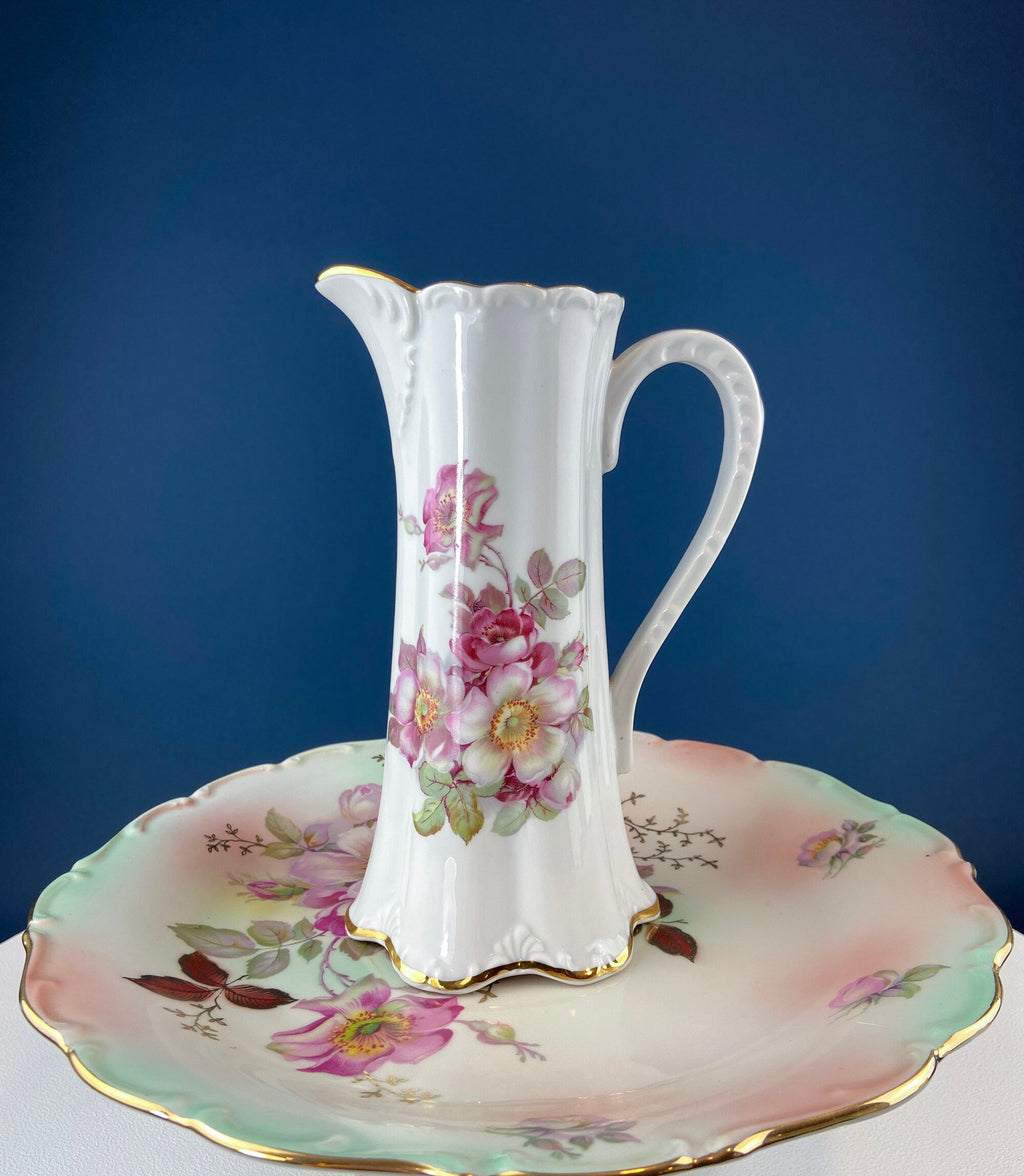 Porcelain hot chocolate pot with pink floral painting and matching saucer