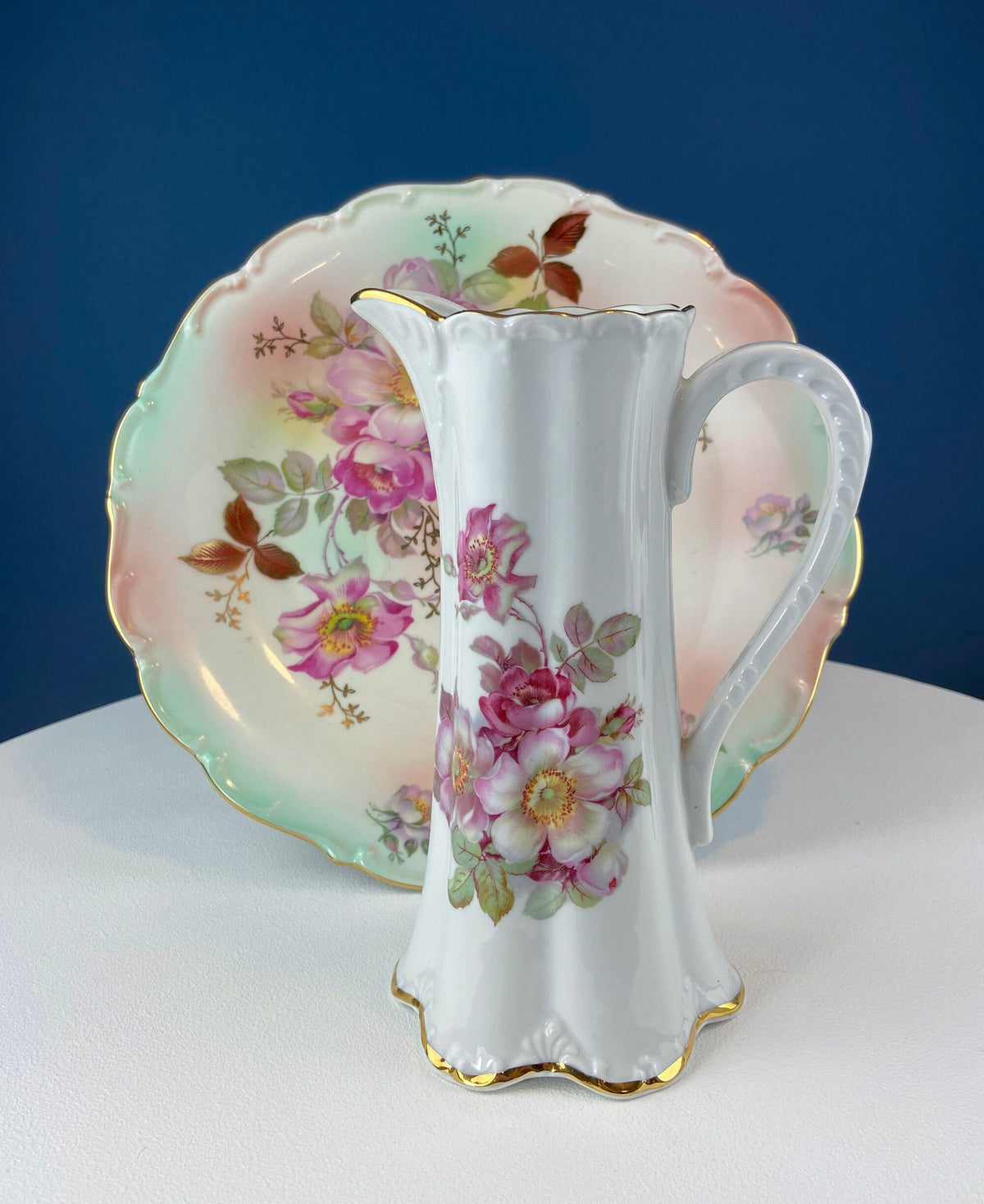 Porcelain hot chocolate pot with pink-purple flower design and gold trim