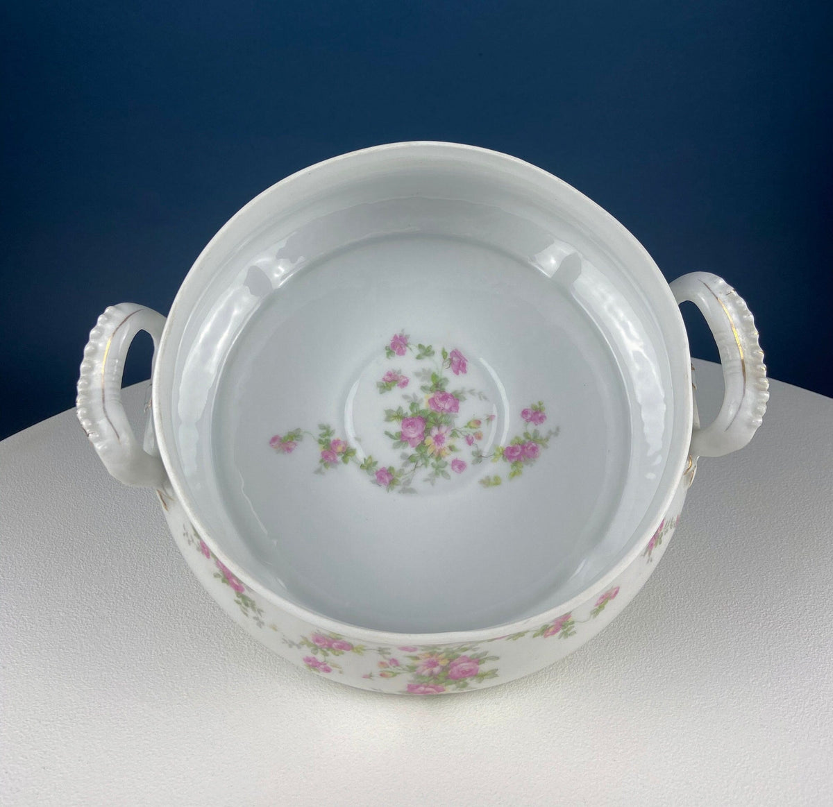 White porcelain tureen base with pink rose floral motif and two bow-shaped side handles