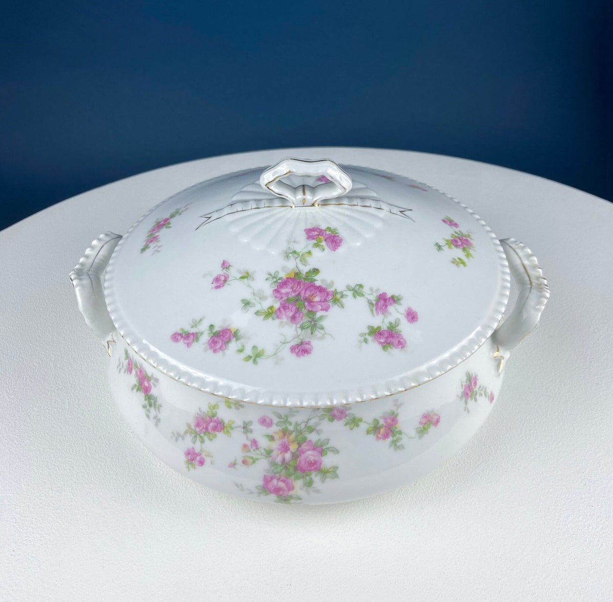 White porcelain tureen with pink rose floral design and domed lid with ornate handle