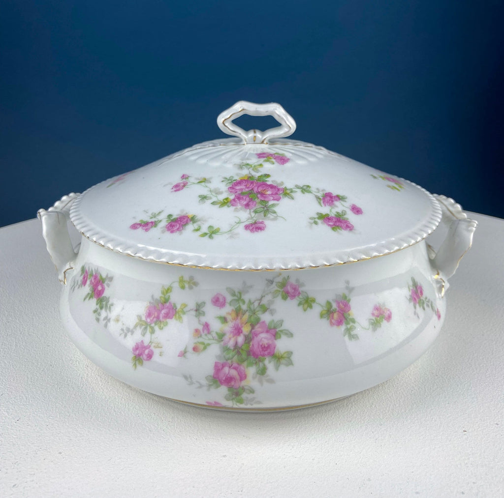 White porcelain tureen lid with pink rose floral pattern and small bow-shaped handles