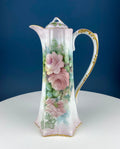 Porcelain hot chocolate pot with gold trim and painted pink roses on front