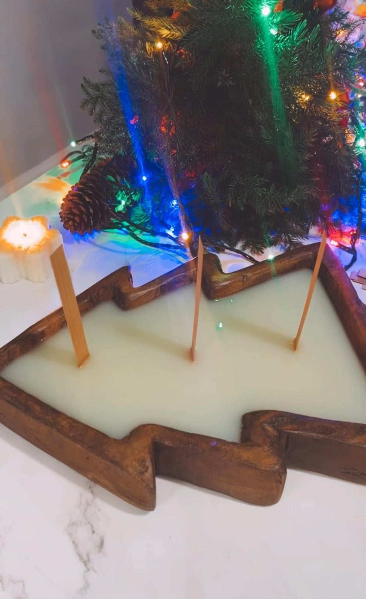 Christmas tree wooden dough bowl candle with white wax and visible wooden wick tips