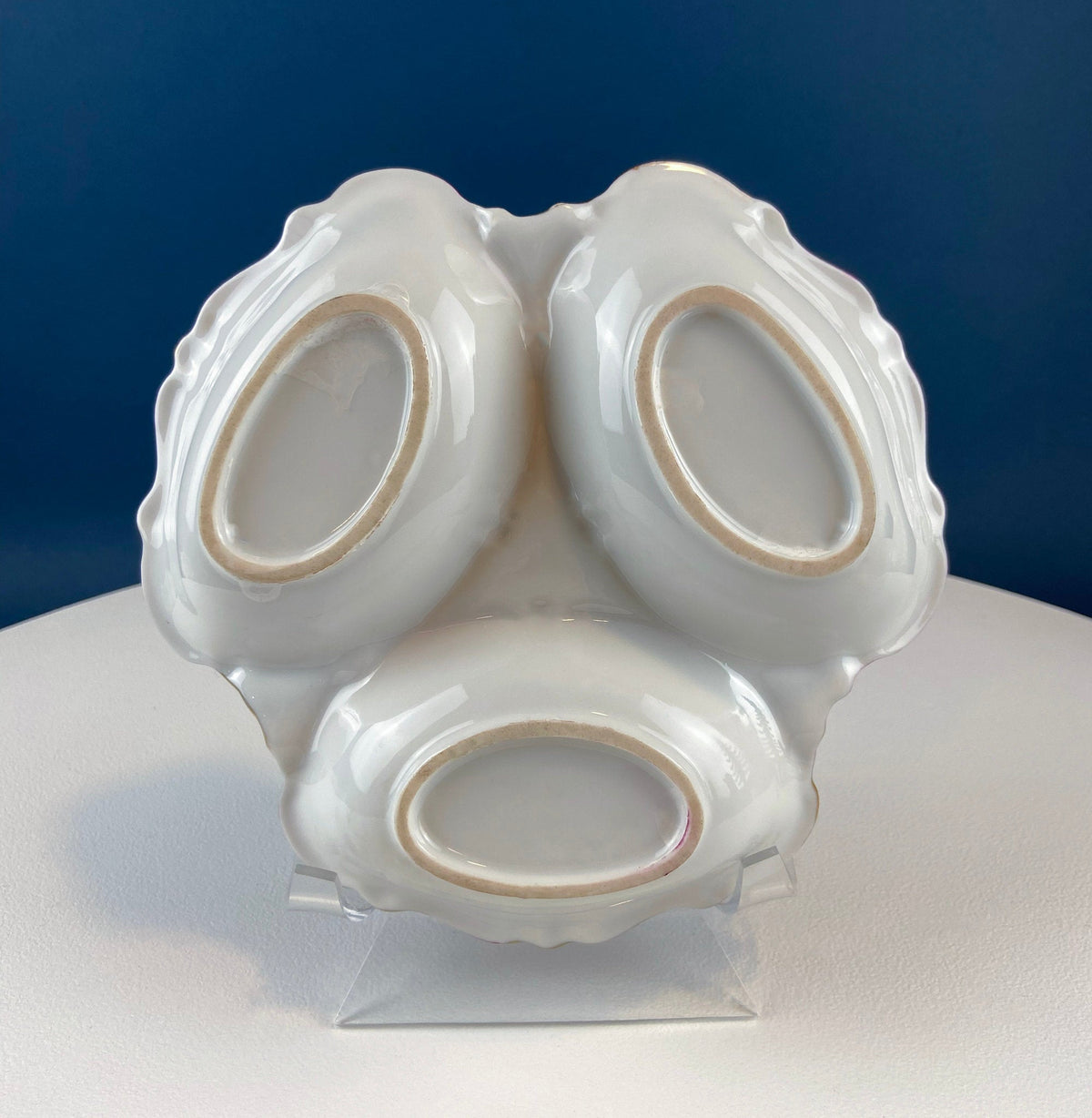 Porcelain divided serving bowl with handle, white sculpted base and three openings