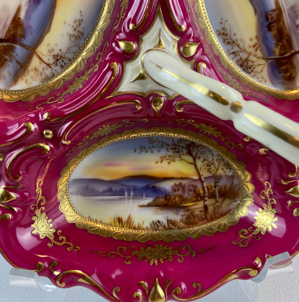 Porcelain divided bowl close-up, magenta glaze, gold frame, central oval landscape scene