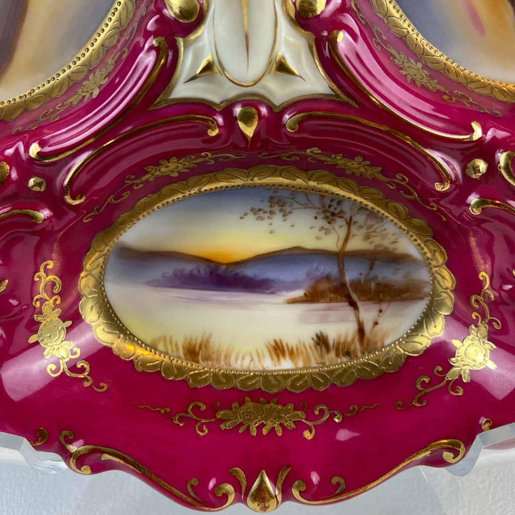 Porcelain divided bowl close-up with oval landscape medallion and gold filigree trim