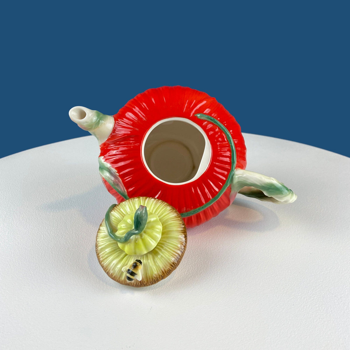 Red poppy teapot lid underside view with central round opening and side handles