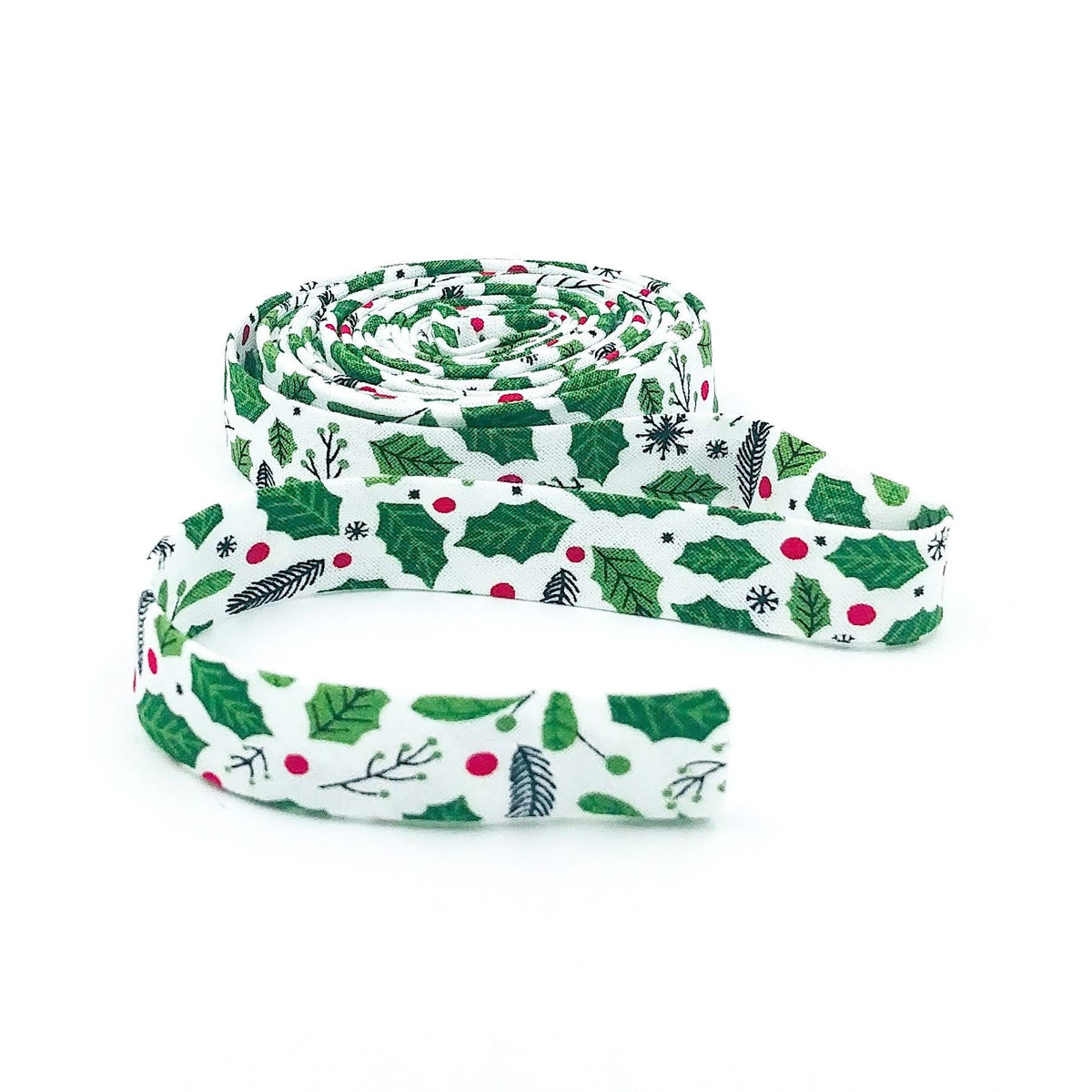 Double-fold 1/2in bias tape, white with green holly leaves and red berries, coiled roll