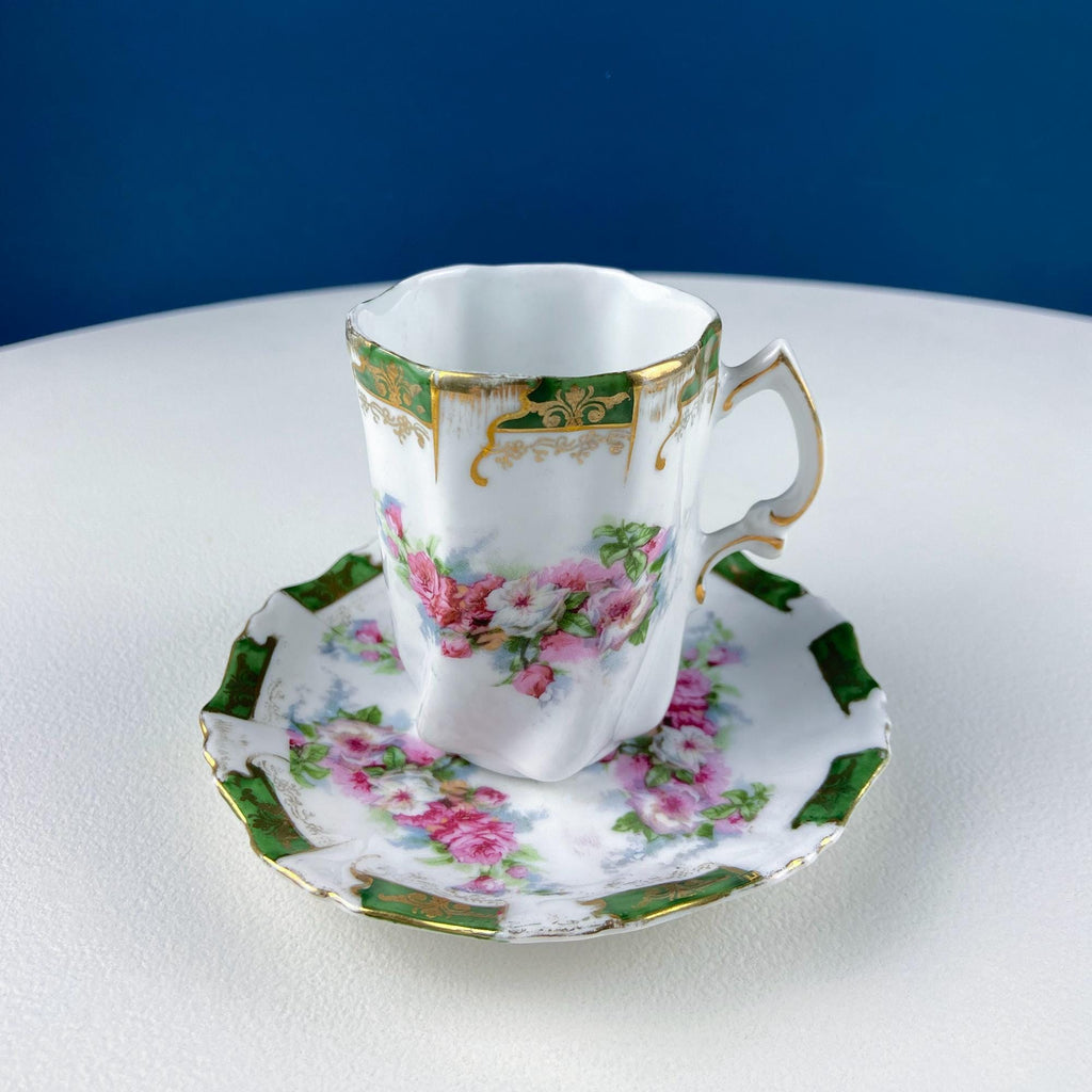 Single floral porcelain cup with gold accents on matching hot cocoa tray