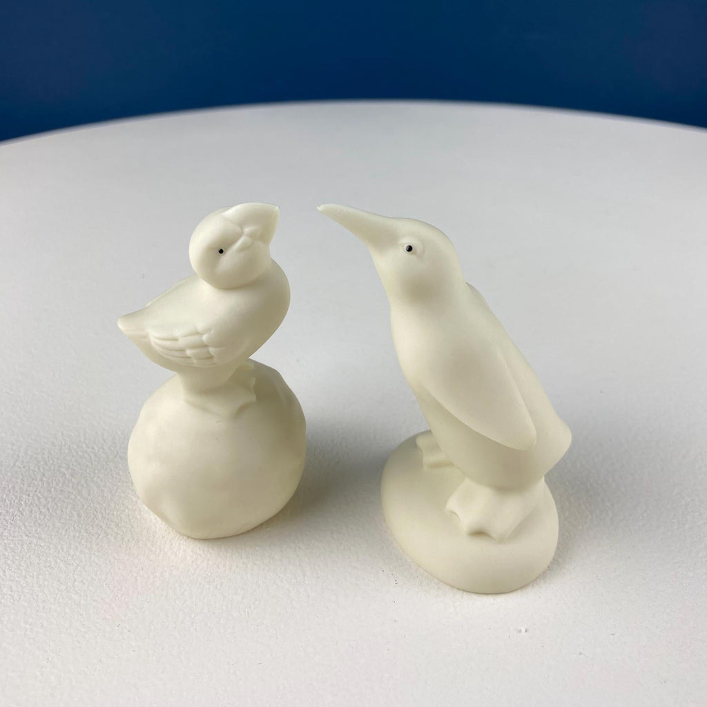 White porcelain bird figurines standing side by side