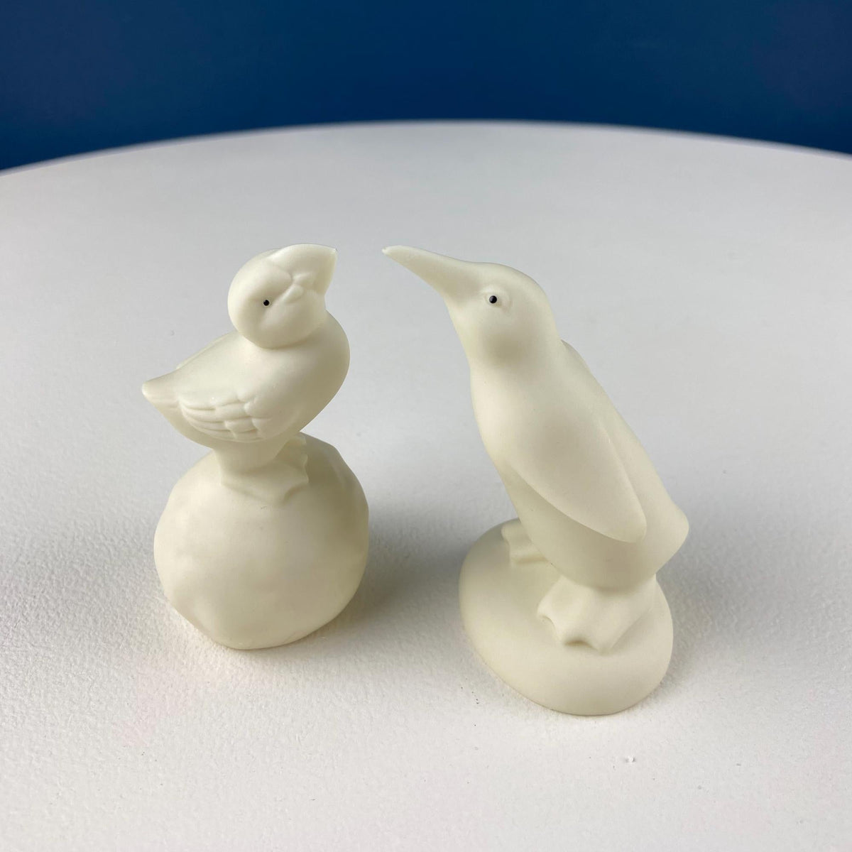White porcelain bird figurines standing side by side
