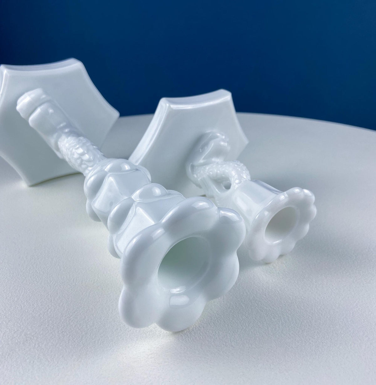 White milk glass dolphin candle holder with sculpted candle cup and tray base