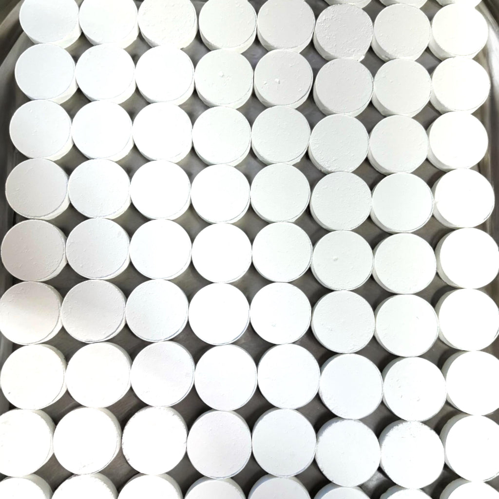 White round shower steamer disks stacked in a grid