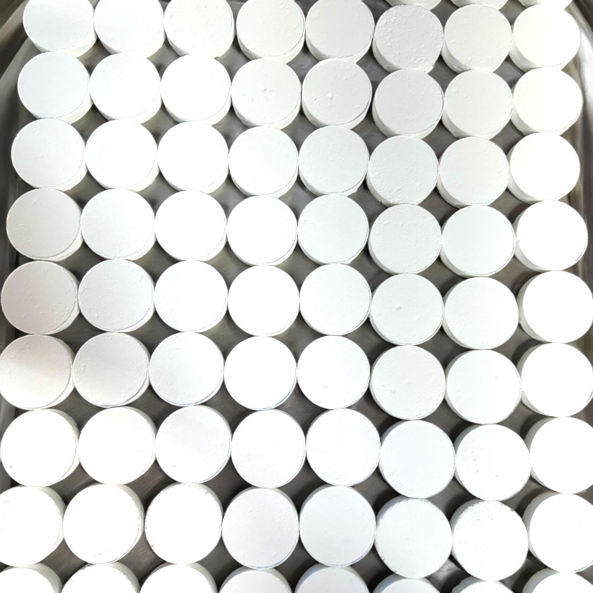 White round shower steamer disks stacked in a grid
