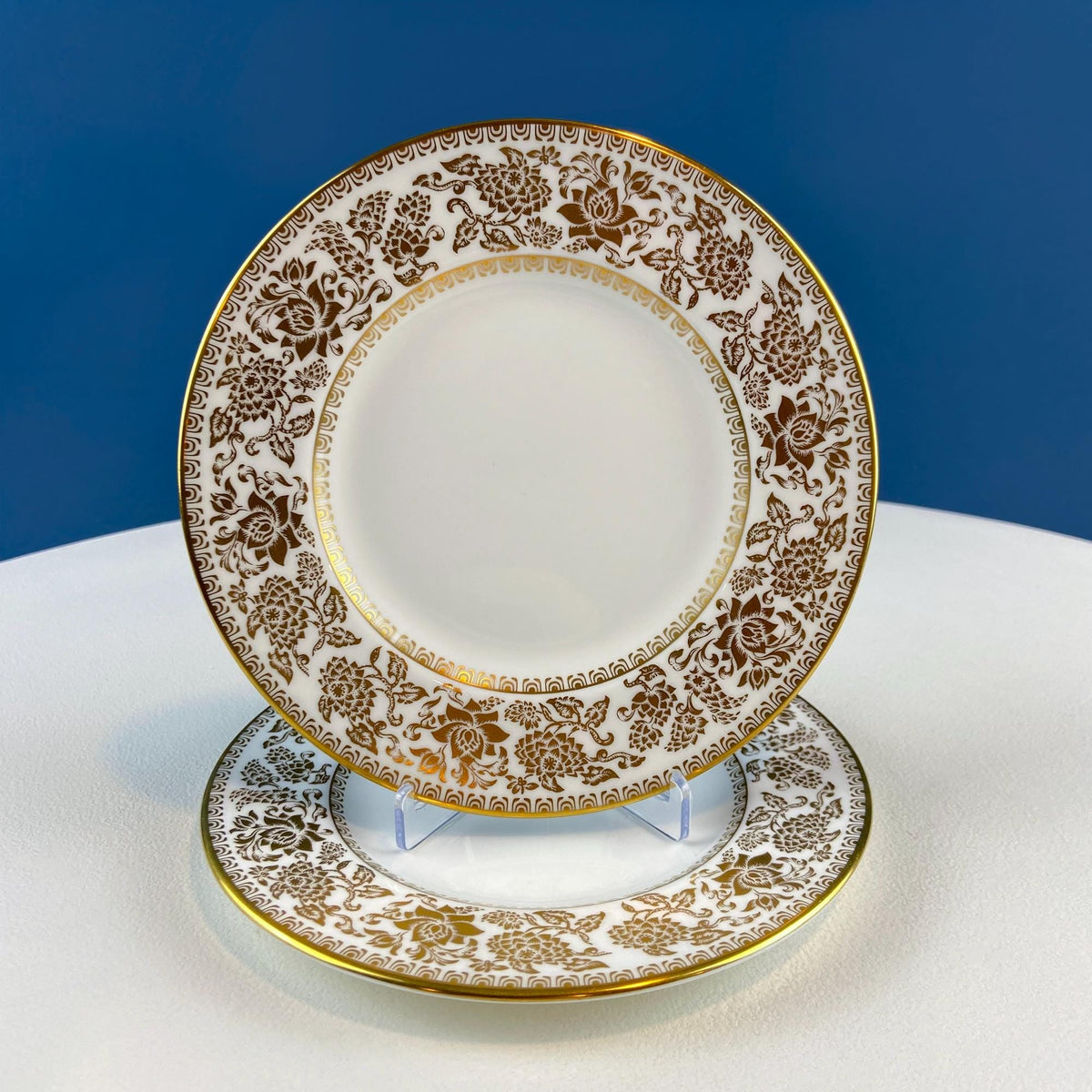 Porcelain salad plate with ornate gold damask medallion and scalloped rim