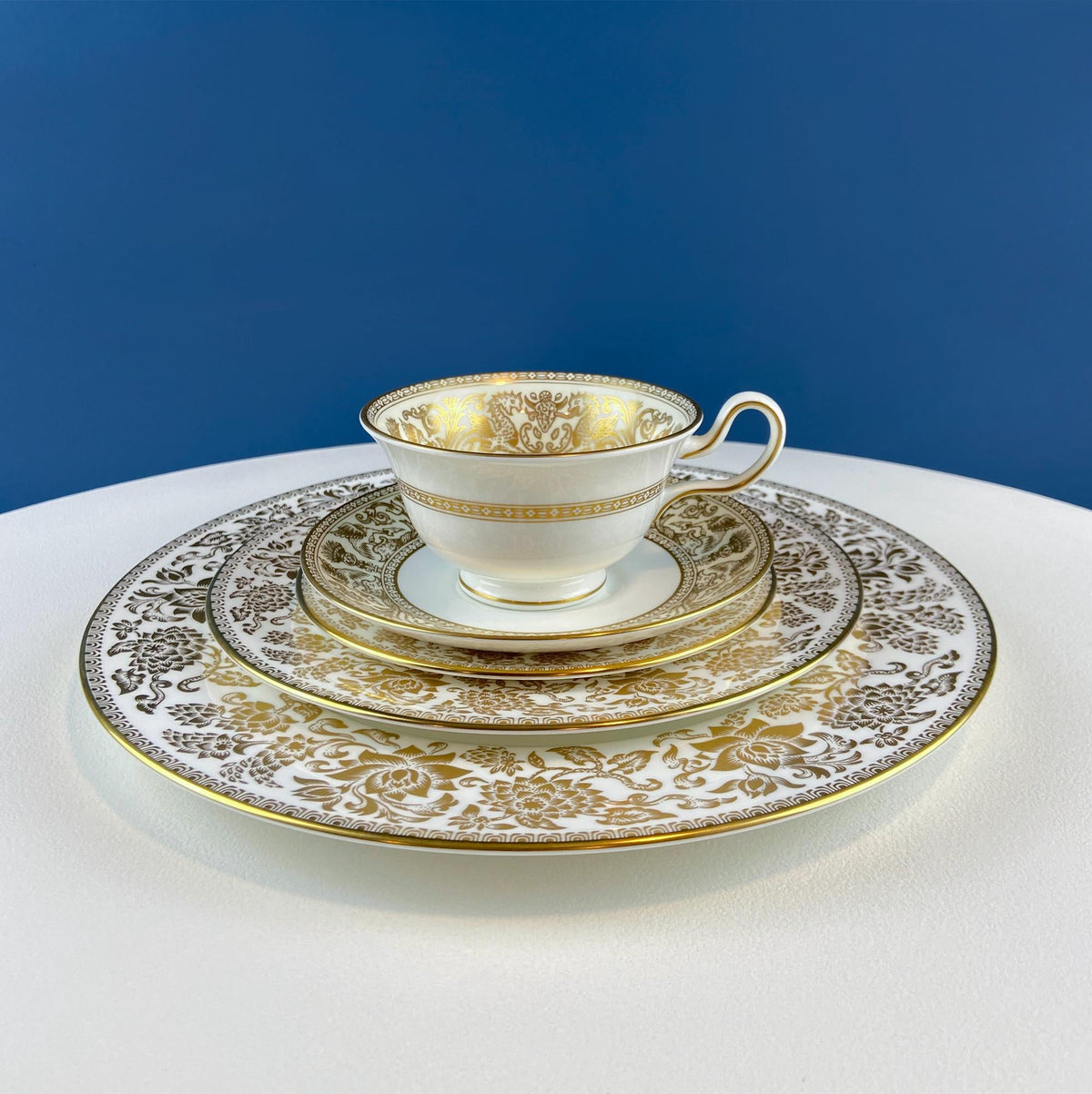 Porcelain cup and saucer set with gold damask plate, scalloped gold trim