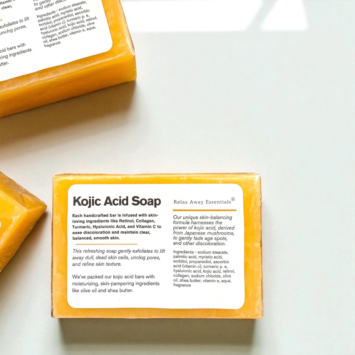 Orange-yellow soap bar with front ingredient label on clear wrapper pack