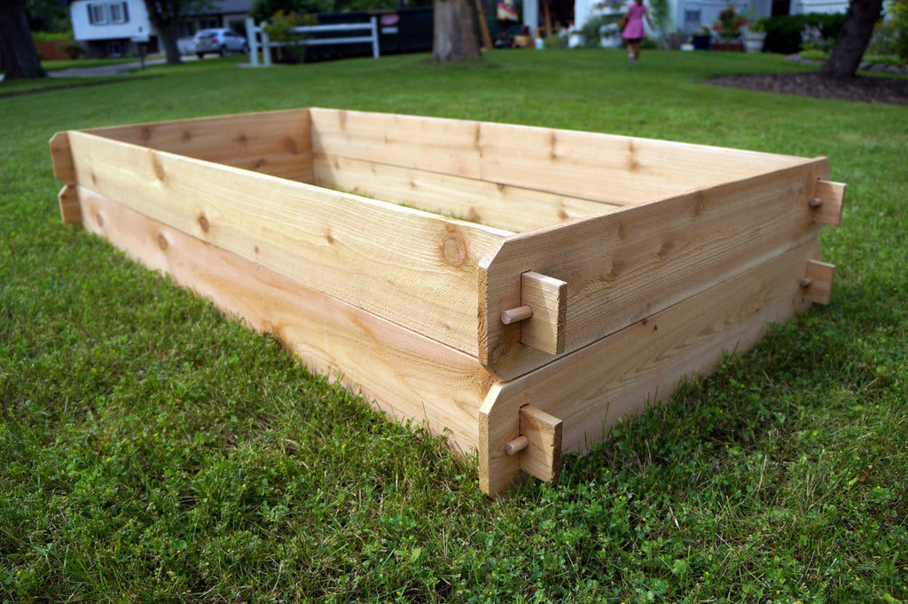 Rectangular natural cedar raised garden bed with slatted sides and corner hardware