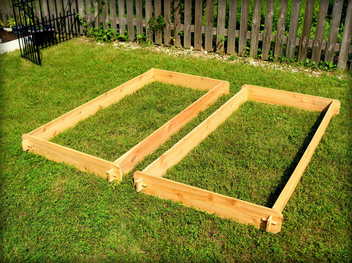 Two natural cedar raised garden beds with corner supports and open frames