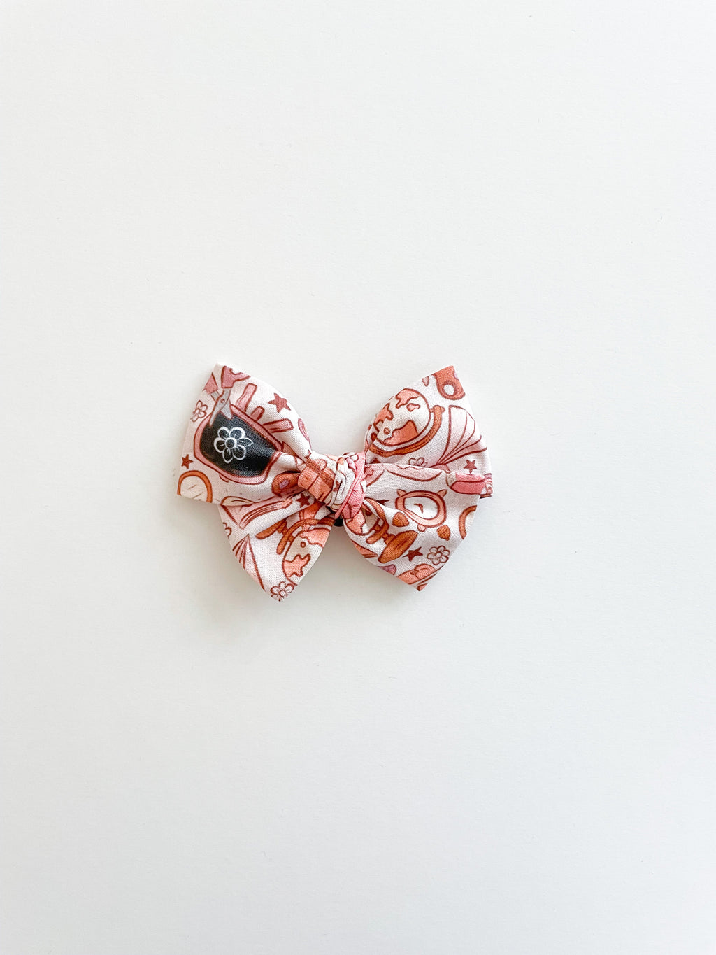Pinwheel hair bow pair with pink, white, and brown novelty pattern bows