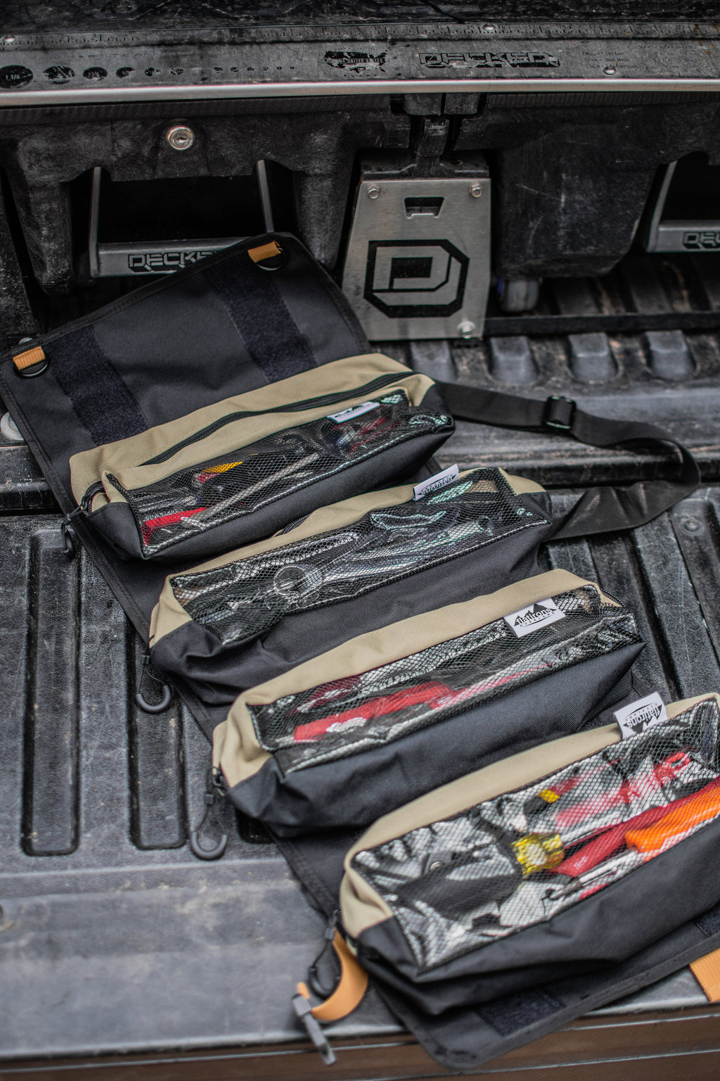 RiPouch™ Gear Roll set of dark pouches with tan straps and zipper pockets laid flat.