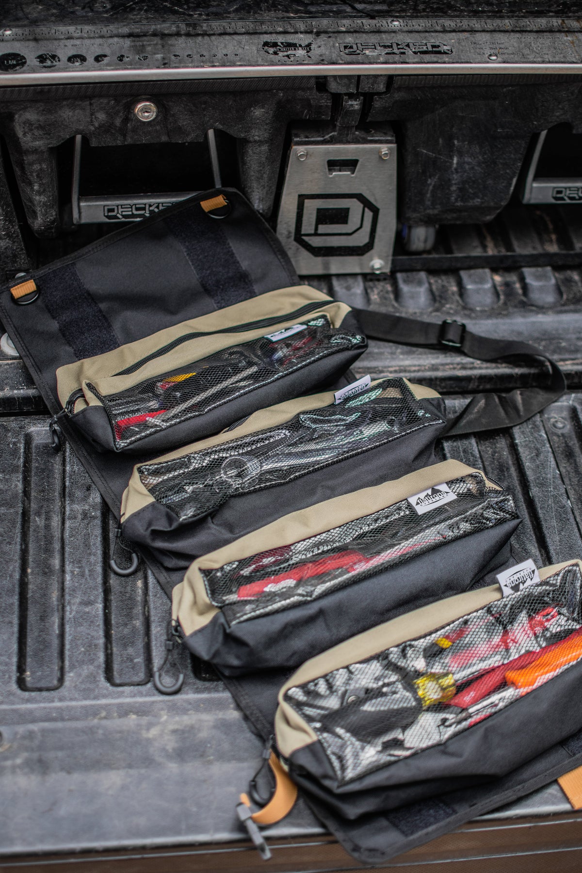 RiPouch™ Gear Roll set of dark pouches with tan straps and zipper pockets laid flat.