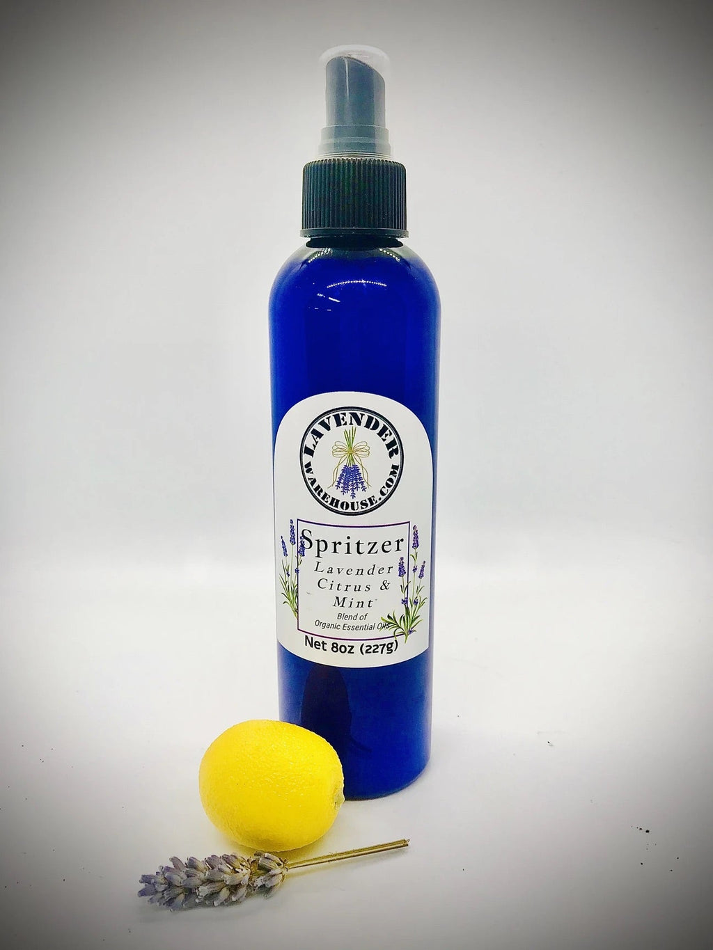 Lavender spritzer bottle with mint label, lemon accent, and dried lavender flowers