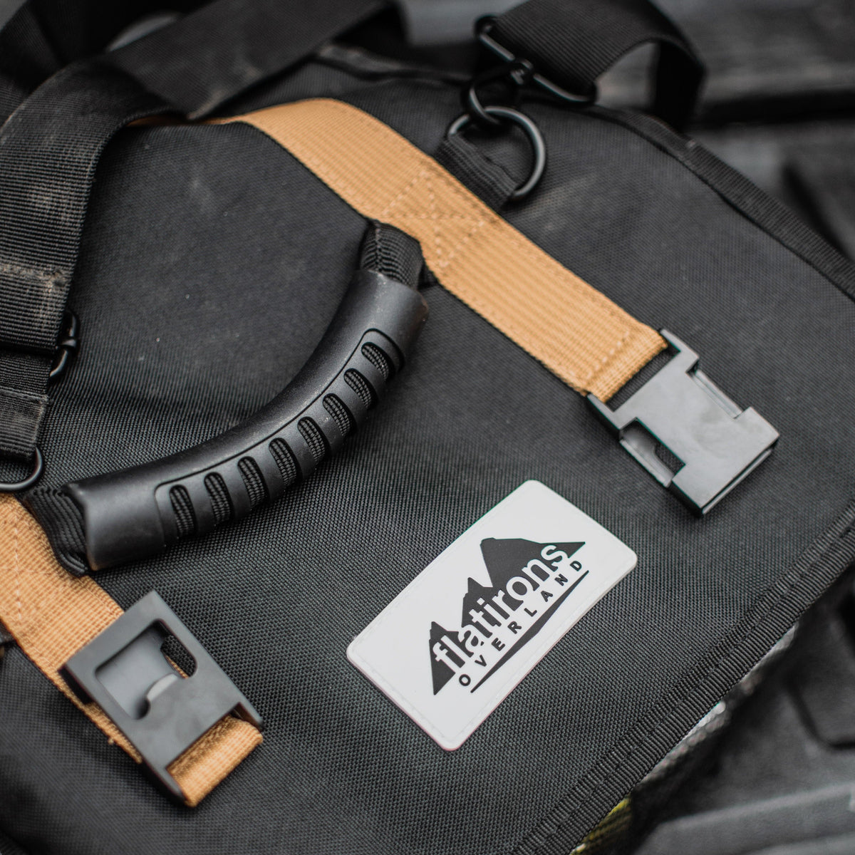 RiPouch Gear Roll close-up with tan straps, metal clips, and logo patch