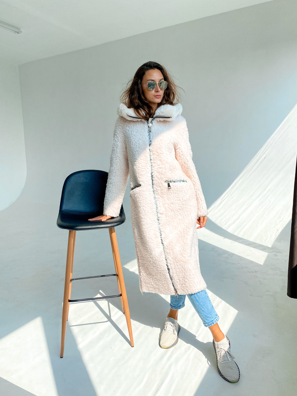 Light blush hooded fur coat with zip front and long, relaxed fit