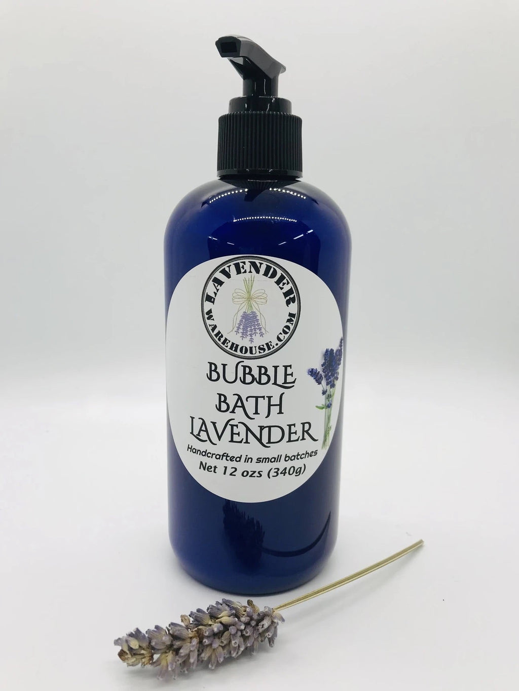 Lavender bubble bath bottle with lavender label and dried lavender sprig beside it