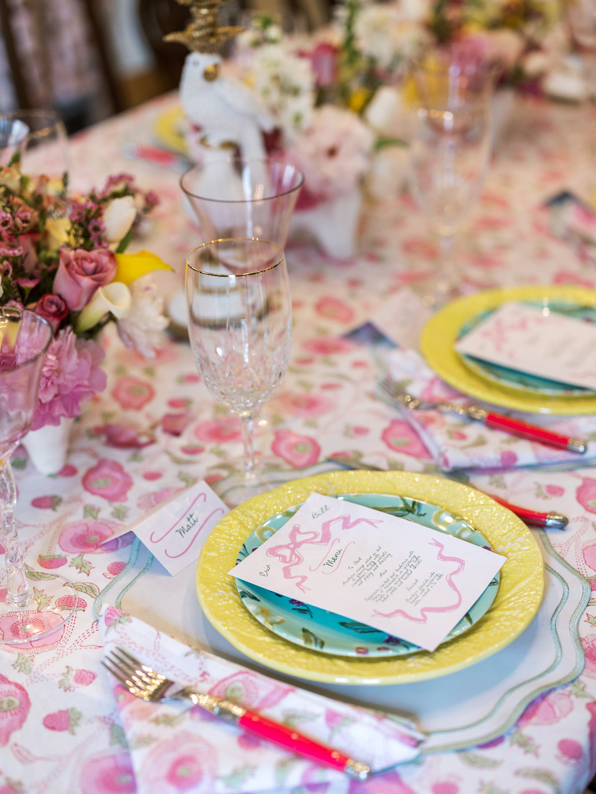 Botanical china plate with yellow and white border and place card on table